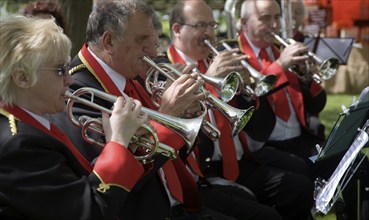 Musicians in a brass band perform during a country fair at Helmingham Hall, Suffolk, England,