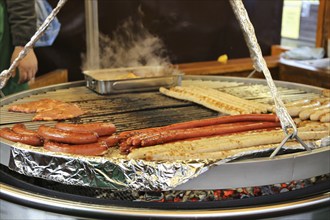 Sausages and steaks on the swing grill