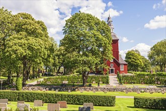 Habo Church an old wooden church on the swedish countryside with the churchyard, Habo, Sweden,