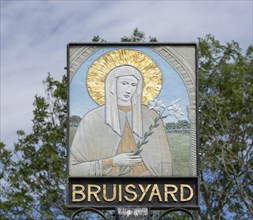 Saint Clare by Anne Smith on Bruisyard village sign, Suffolk, England, UK