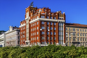 Art Deco building Palazzo Aedes or Palazzo Rosso, waterfront promenade, Trieste, harbour town on