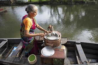 Tealady, 83 years old, bottles Indian tea, Backwaters, Kumarakom, Kerala, India, Asia