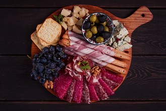 Appetizer, assortment, set, sausage, and cheese, on a wooden board, top view, no people