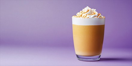 Banner with drinking glass with seasonal pumpkin spice latte on violet background with copy space.