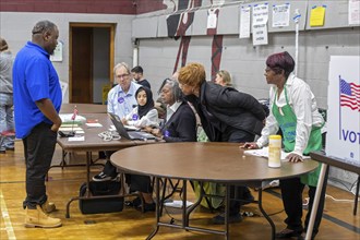 Detroit, Michigan USA, 5 November 2024, Election officials study their compouter as voters cast