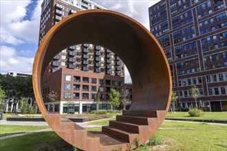 Walk-in steel sculpture on Maashaven Noordzijde Street, new high-rise residential buildings in the