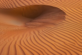 Wind-sculpted sand structure in the Rub al Khali desert, Dhofar province, Arabian Peninsula,