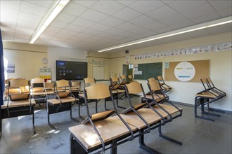 Classroom of a fourth grade, after school, the building is older but in good condition, modern