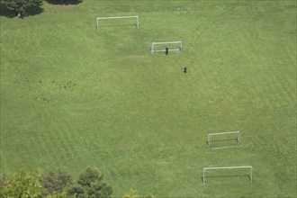 View from Nassau Castle to football field with Tor tor and two players in Lahntal, playground, view