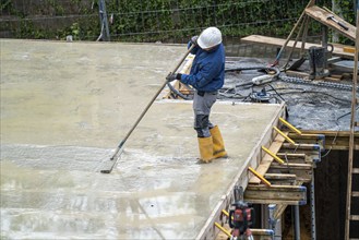 Construction site, concreting, the floor slab of a building is concreted, the fresh concrete is