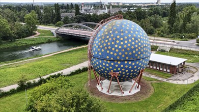 The spherical gas tank designed by artist Rolf Glasmeier on the Rhine-Herne Canal, Gelsenkirchen,