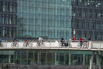 Cyclists on the Bryggebroen cycle and footpath bridge over the harbour, Sydhavnen, Copenhagen is