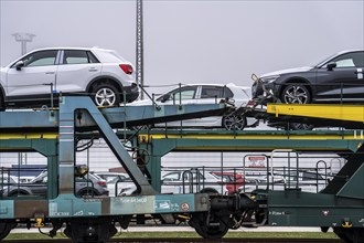 Freight train, car transporter brings new cars from Germany, for export by ship, to the port of