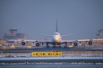 Lufthansa Boeing 747-8, on the taxiway to Runway West, Frankfurt FRA Airport, Fraport, in winter,