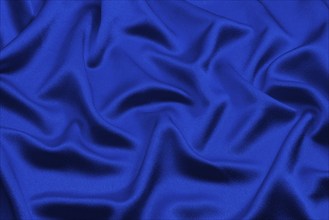 Blue silk lies in soft, irregular folds