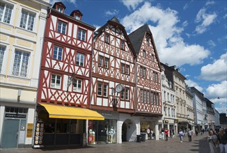 Half-timbered houses in an old town centre with shops, blue sky and pedestrian zone, Hauptmarkt,