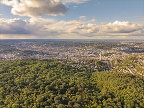 Wide city and forest panorama under a partly cloudy sky with distant view, Stuttgart, Germany,