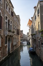 House facades with Venetian flag on a canal, Venice, Veneto, Italy, Europe