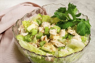 Waldorf salad, celery salad with apple, in a glass salad bowl, natural light, homemade, no people