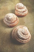 Bakery product, lemon twist, with white glaze, sweet bun, muffin, pastries, top view, no people