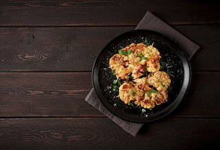 Steak, cauliflower, with cheese, spices, homemade, on a wooden table, dark background, close-up,