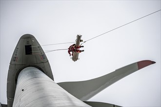 Height rescuers from the Oberhausen professional fire brigade practise abseiling from a wind