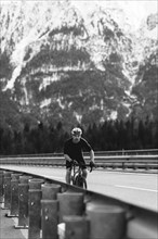 Road bike rider in spring between Lechtal and Tannheimer Tal in front of picturesque scenery of the