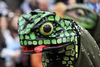 Person masked as a lizard at the carnival parade of the Wey guild on Rose Monday, Güdismäntig,