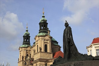 Jan Hus Monument on Old Town Square and the baroque St Nicholas Church, Prague, Czech Republic,