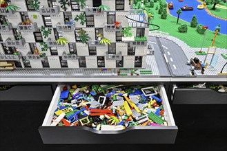 Drawer toy building blocks and Lego apartment block with surroundings