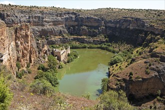 Canoes in the gorge on the Duratón river, on the left the Franciscan monastery of La Hoz, Hoces del