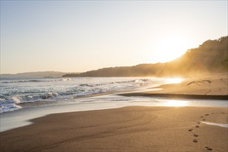 Sandy beach beach and sea at sunset, Playa Cocalito, coastal landscape, Pacific coast, Nicoya