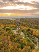 The observation tower stands majestically above the autumnal forest in a sea of colour,