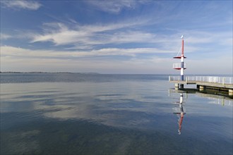 View of calm sea with jetty and cloudy sky, peaceful atmosphere, Rechlin, Müritz,