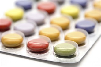 Colourful tablets packed in plastic, tablet addiction, drug addiction, studio