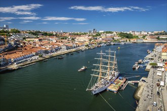 Aerial view of Porto city and Vila Nova de Gaia and Douro river with moored sailling ship from Dom