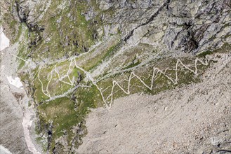 Serpentines of hiking trail up to mountain hut Cabane de Moiry, aerial view, Valais, Switzerland,