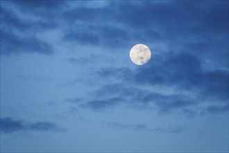 Full moon and clouds at dusk, Switzerland, Europe