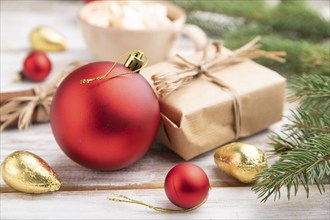 Christmas or New Year composition. Decorations, box, red balls, cinnamon, fir and spruce branches,