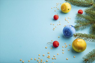 Christmas or New Year composition. Decorations, blue, red, yellow balls, fir and spruce branches,