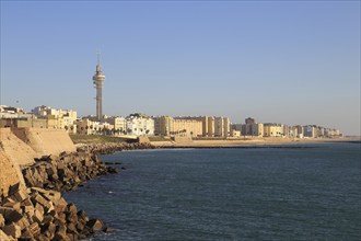 Coastal view east of rock armour coastal defences near city centre, Cadiz, Spain, Europe