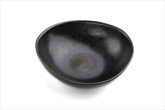 Empty black ceramic bowl isolated on white background. Side view, close up