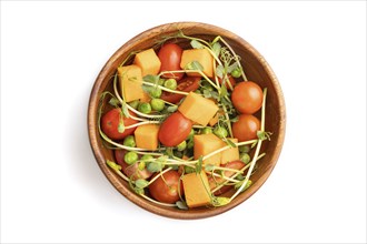 Vegetarian vegetable salad of tomatoes, pumpkin, microgreen pea sprouts isolated on white