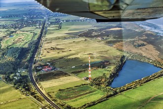 Railway tracks lead through meadows and fields, Morsum Teich Nösse Kuhle and transmission mast, NDR