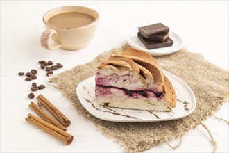 Zephyr or marshmallow cake with cup of coffee on white wooden background and linen textile. side