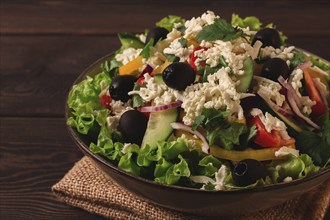 Traditional Bulgarian dish, Shopska salad, on a wooden table, salad of fresh vegetables, top view,