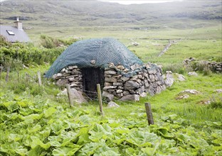 Stone roundhouse structure used as croft storage Isle of Barra, Outer Hebrides, Scotland, UK