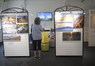 People watching a multimedia image display in the Dartmoor national park visitor centre,