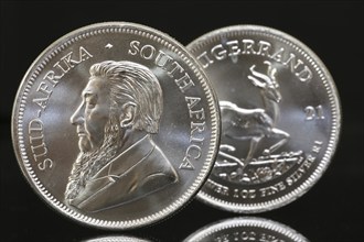 Close-up of two Krugerrand silver coins