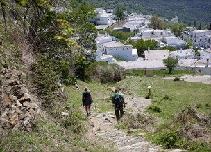 Walkers arriving at the village of Capileira, High Alpujarras, Sierra Nevada, Granada province,